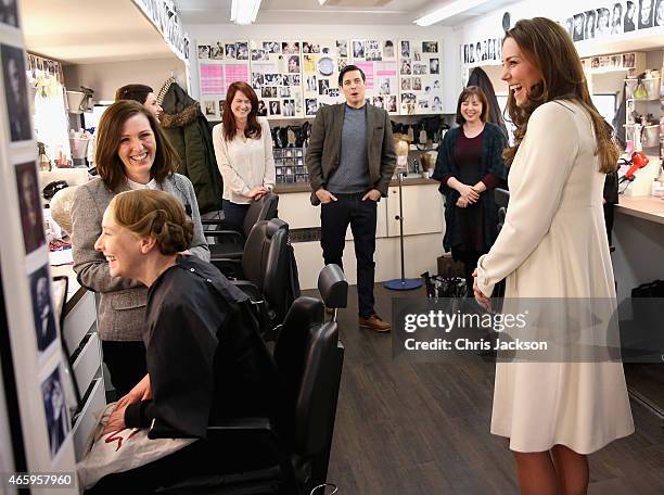 Catherine, Duchess of Cambridge chats to Nic Collins in hair and make up as actress Phyllis Logan is made-up during an official visit to the set of...