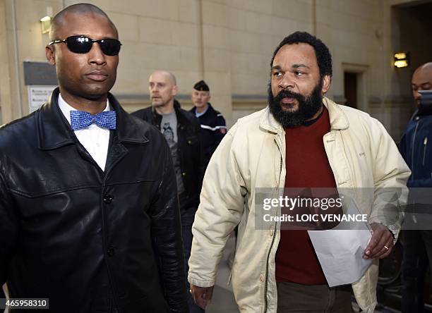 French controversial comic Dieudonne M'bala M'bala arrives at the Paris courthouse on March 12 for the trial of French far-right writer Alain Soral ,...