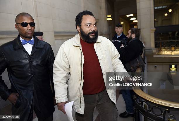 French controversial comic Dieudonne M'bala M'bala arrives at the Paris courthouse on March 12 for the trial of French far-right writer Alain Soral,...