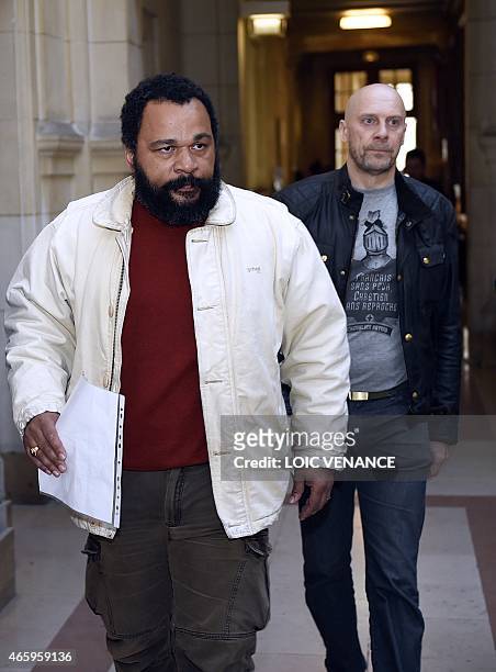 French controversial comic Dieudonne M'bala M'bala and French far-right writer Alain Soral arrive at the Paris courthouse on March 12 for Soral's...