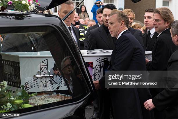 Gary and Martin Kemp help carry the coffin of Visage star Steve Strange from the hearse during his funeral at All Saints Church on March 12, 2015 in...