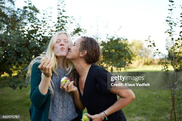 motther & daughter eating apples from the tree - people kissing bildbanksfoton och bilder