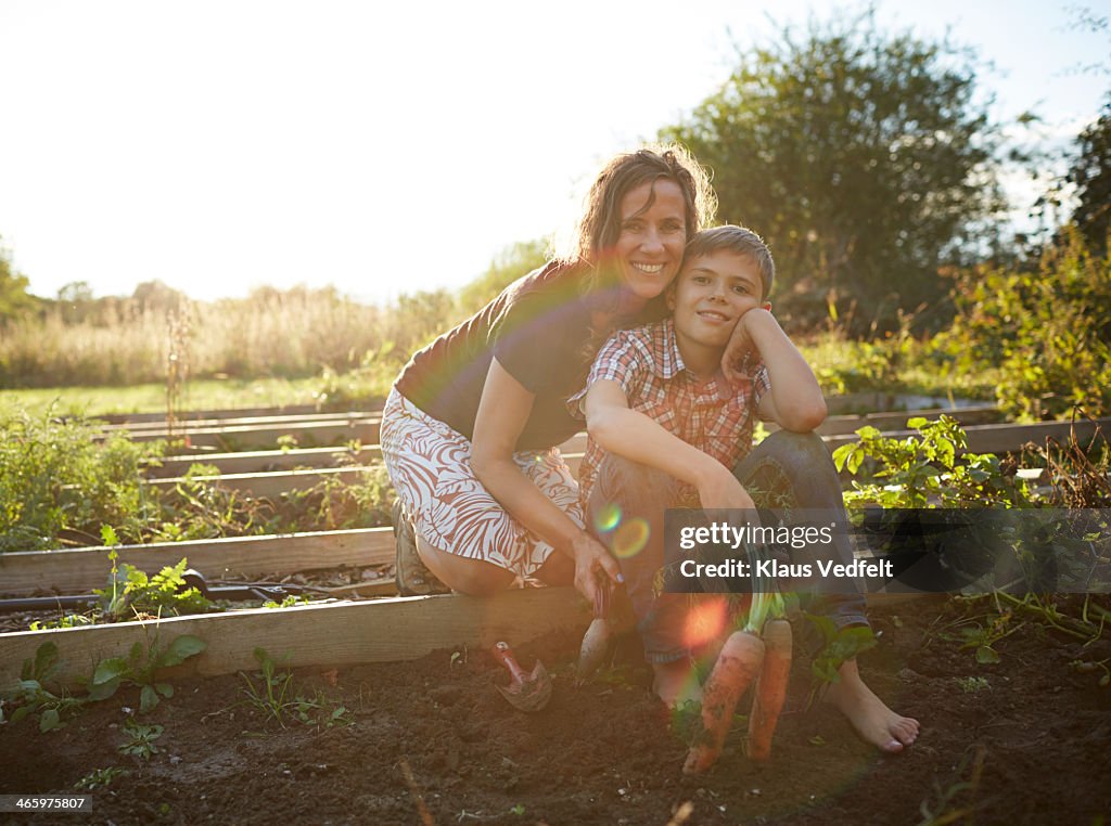 Portrait of mom & son in their vegetable garden