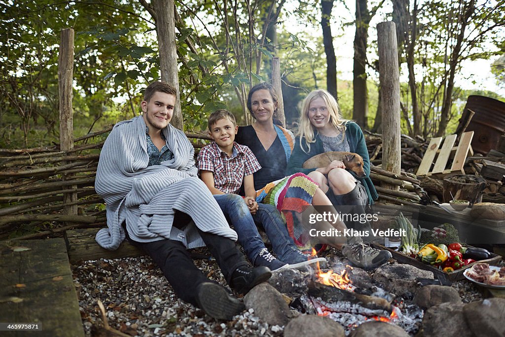Family sitting in front of bonfire
