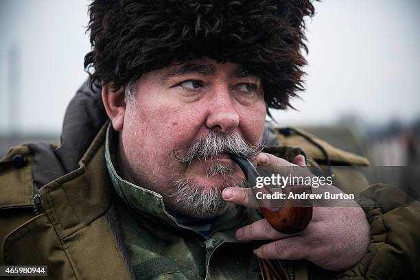 An ethnically Cossack pro-Russian rebel smokes a pipe after a skills performance on March 12, 2015 in Makeevka, Ukraine. The conflict between Ukraine...