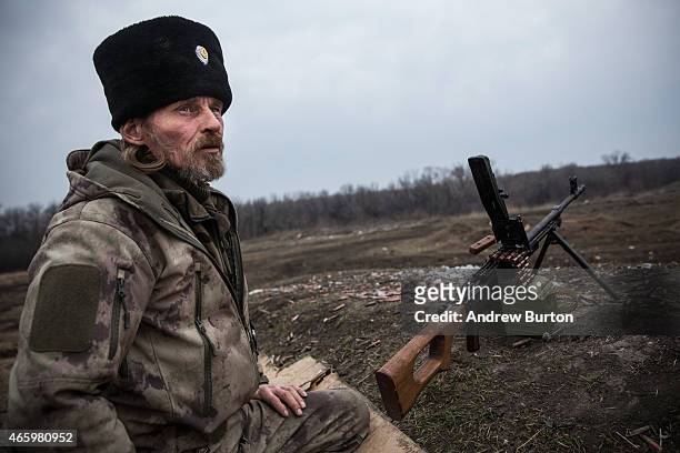 An ethnically Cossack pro-Russian rebel practices his firearms skills at a firing range on March 12, 2015 in Donetsk, Ukraine. The conflict between...