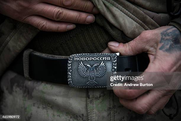 An ethnically Cossack pro-Russian rebel displays a belt buckle that says "New Russia" at a firing range on March 12, 2015 in Donetsk, Ukraine. The...