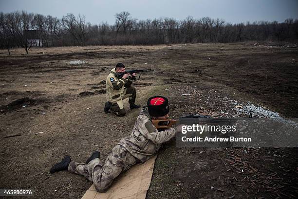 Ethnically Cossack pro-Russian rebels practice their firearms skills at a firing range on March 12, 2015 in Donetsk, Ukraine. The conflict between...