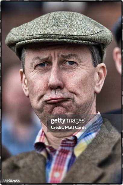 Racegoer reacts as he watches a race on the third day of the Cheltenham Festival on March 12, 2015 in Cheltenham, England. Thousands of racing...