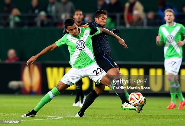 Luiz Gustavo of VfL Wolfsburg and Fredy Guarin of Milano battle for the ball during the UEFA Europa League Round of 16 first leg match between VfL...