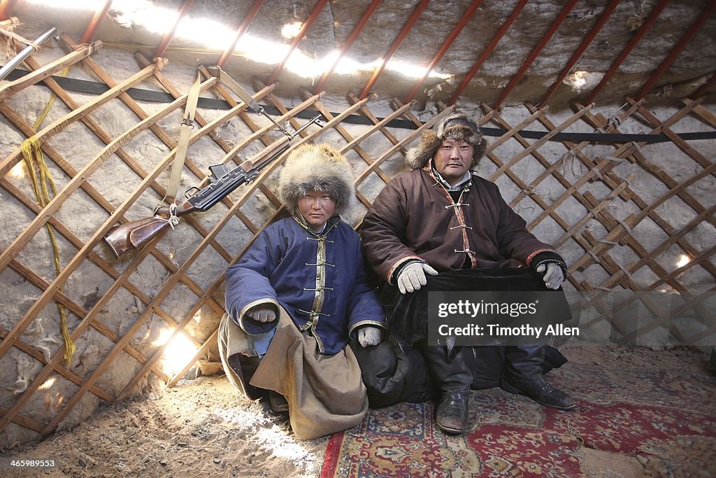 Mongolian nomadic hunters rest inside ger