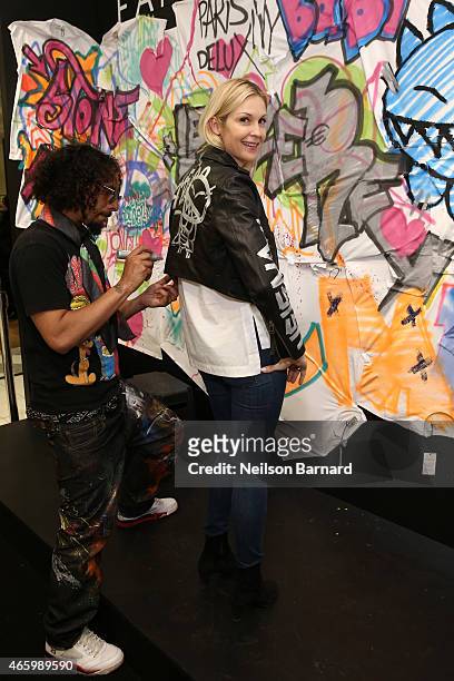 Actress Kelly Rutherford and Le H attend the "Faith Connexion Street Art Tour" hosted by Saks Fifth Avenue and Marie Claire at Saks Fifth Avenue on...