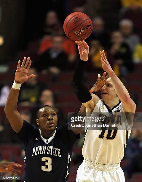 Mike Gesell of the Iowa Hawkeyes passes as Devin Foster of the Penn State Nittany Lions gets a hand in his face during the second round of the 2015...