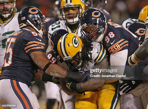 Eddie Lacy of the Green Bay Packers is hit by Lance Briggs, Shea McClellin and Corey Wootton of the Chicago Bears at Soldier Field on December 29,...