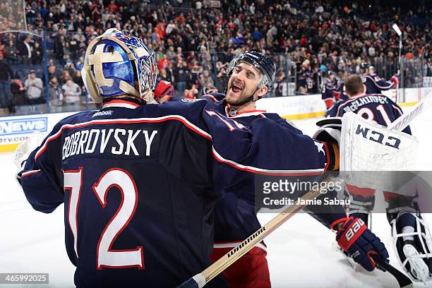 Nick Foligno of the Columbus Blue Jackets celebrates with Sergei Bobrovsky of the Columbus Blue Jackets after defeating the Washington Capitals 5-2...