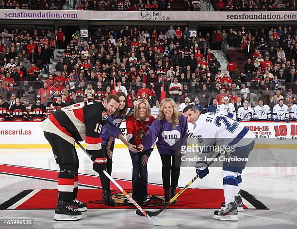 Caroline Mulack, Stephanie Richardson and Mary Deacon take part in a ceremonial faceoff on Hockey Talks night, in support of Do It For Daron with...