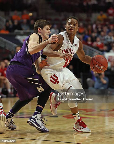 Dave Sobolewski of the Northwestern Wildcats grabs Yogi Ferrell of the Indiana Hoosiers during the second round of the 2015 Big Ten Men's Basketball...