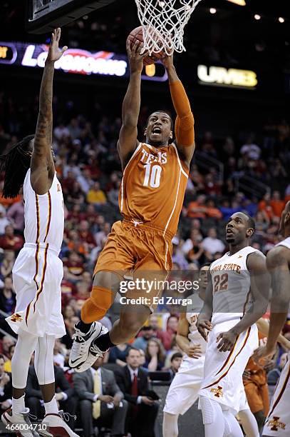 Jonathan Holmes of the Texas Longhorns goes up for a shot against Jameel McKay Dustin Hogue of the Iowa State Cyclones during the quarterfinal round...