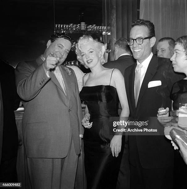 Actress Marilyn Monroe chats with Jackie Gleason at is birthday party at Toots Shor's Restaurant on February 26, 1955 in New York City, New York.