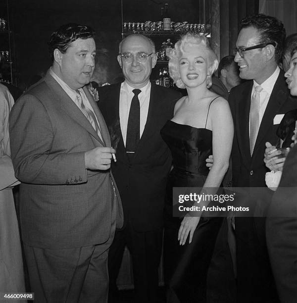 Actress Marilyn Monroe chats with Jackie Gleason at is birthday party at Toots Shor's Restaurant on February 26, 1955 in New York City, New York.