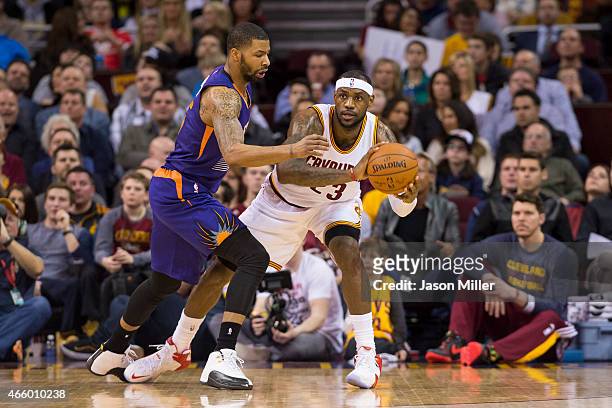 Marcus Morris of the Phoenix Suns guards LeBron James of the Cleveland Cavaliers during the first half at Quicken Loans Arena on March 7, 2015 in...