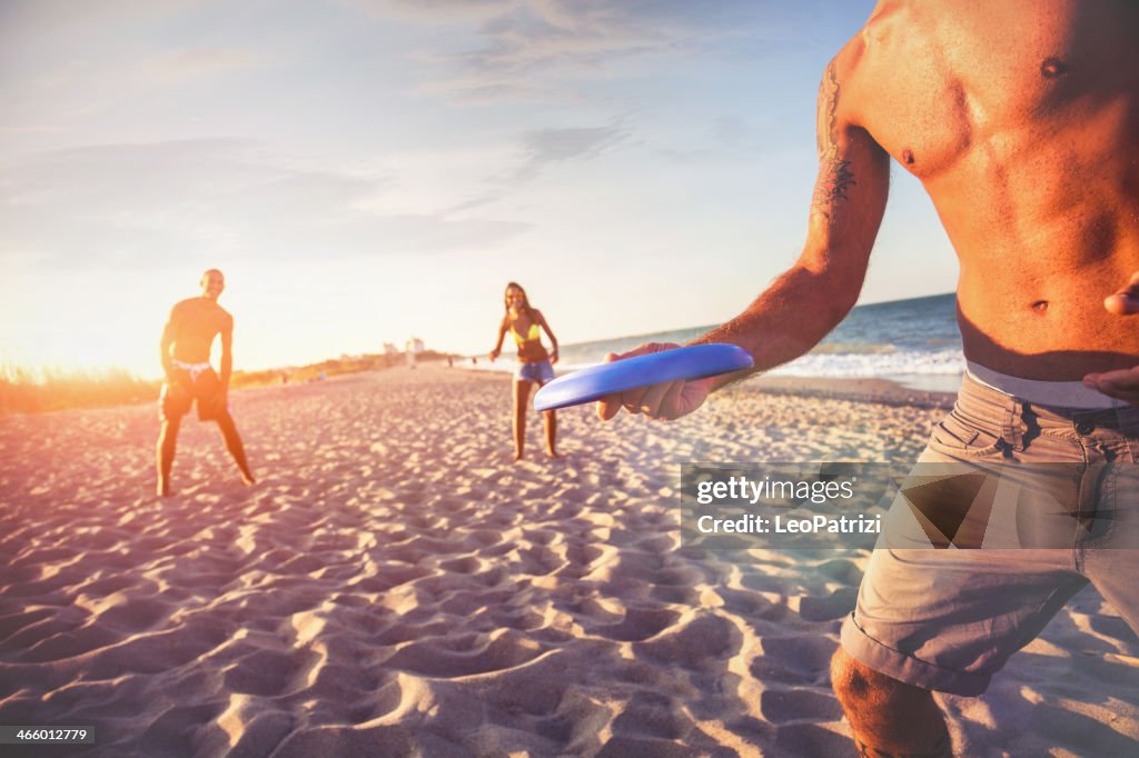 Playing on the beach with a freesbi