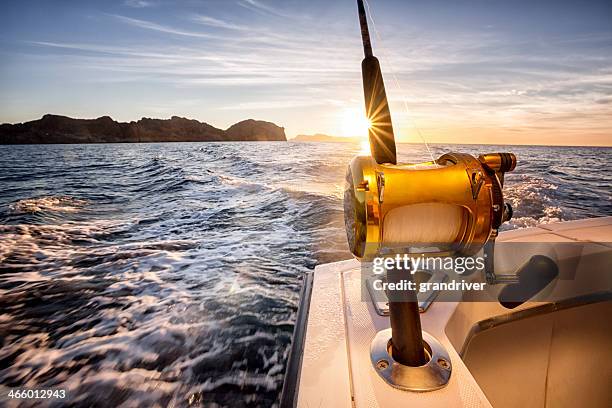 ocean fishing reel on a boat in the ocean - fishing stockfoto's en -beelden