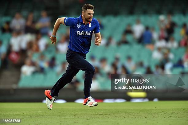 England's paceman James Anderson runs off the field due to rain during the 2015 Cricket World Cup Pool A match between England and Afghanistan at the...