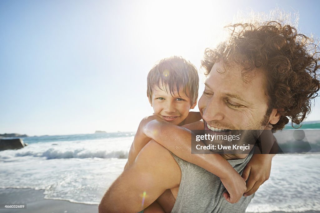 Father giving son piggy back ride