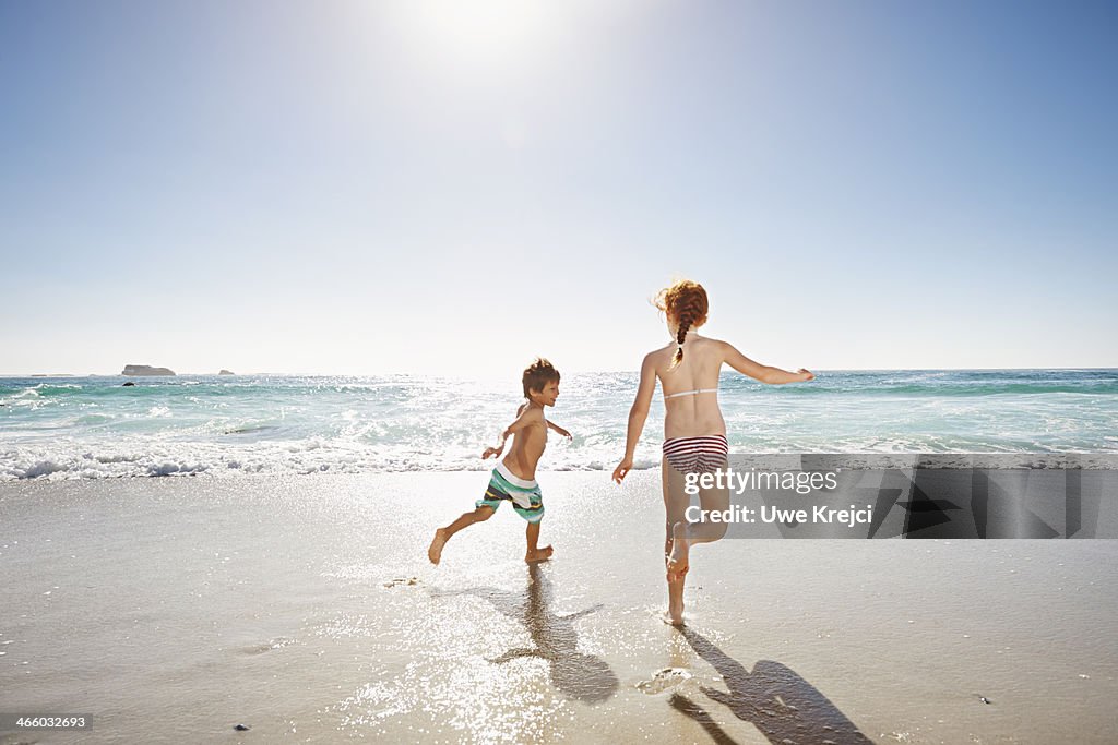 Children (6 -8 years) playing by the ocean
