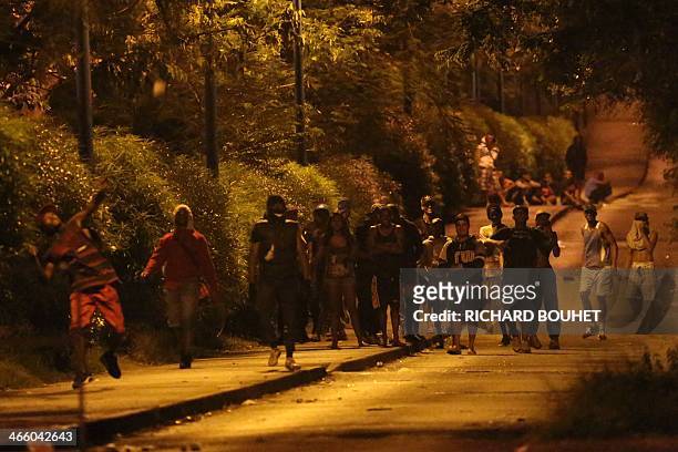 Youths clash with police, unseen, on January 30, 2014 in the Chaudron district of Saint-Denis de La Reunion, French Indian Ocean. Clashes erupted...