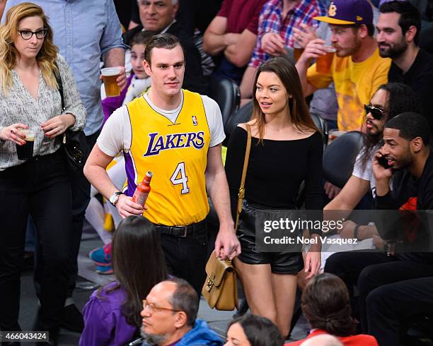 Cooper Hefner and Scarlett Byrne attend a basketball game between the New York Knicks and the Los Angeles Lakers at Staples Center on March 12, 2015...