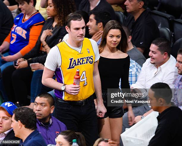 Cooper Hefner and Scarlett Byrne attend a basketball game between the New York Knicks and the Los Angeles Lakers at Staples Center on March 12, 2015...