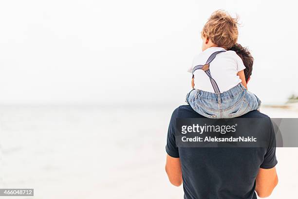 exploring the beach together - carrying on shoulders stock pictures, royalty-free photos & images