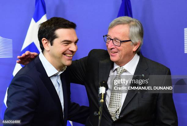 Greece's Prime Minister Alexis Tsipras is welcome by European Commission President Jean-Claude Juncker at the European Commission in Brussels on...