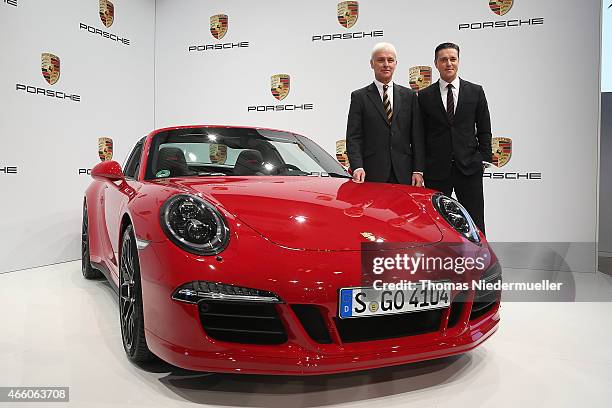 Matthias Mueller , CEO of Porsche AG und Lutz Meschke , CFO of Porsche AG pose next to a Porsche Targa 4 GTS at the Porsche AG annual press...