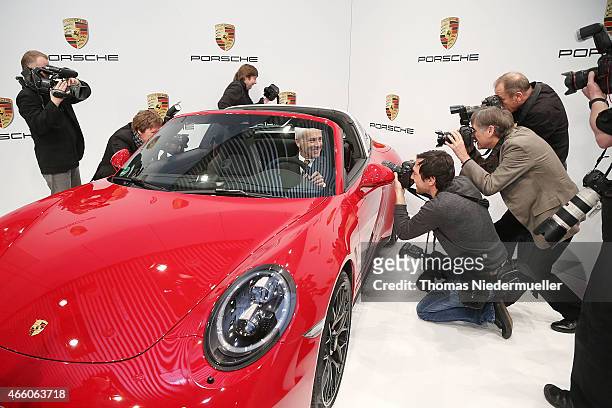 Matthias Mueller, CEO of Porsche AG poses in a Porsche Targa 4 GTS at the Porsche AG annual press conference on March 13, 2015 in Stuttgart, Germany....