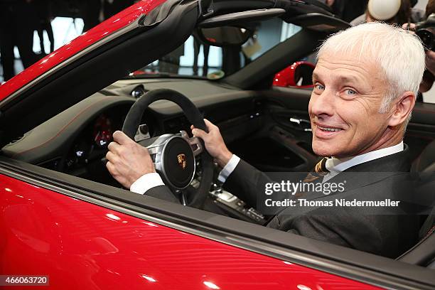 Matthias Mueller, CEO of Porsche AG poses in a Porsche Targa 4 GTS at the Porsche AG annual press conference on March 13, 2015 in Stuttgart, Germany....