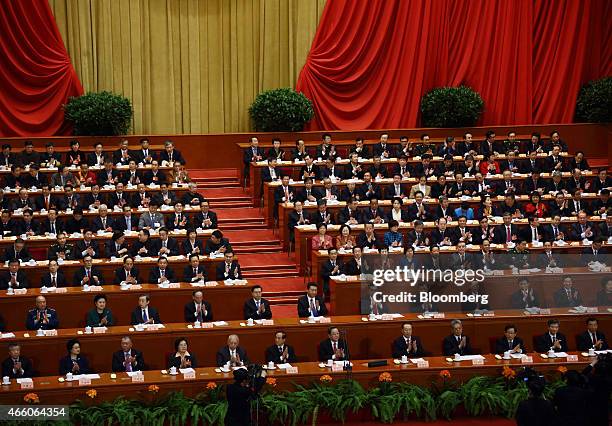 Xi Jinping, China's president, second row center, and Li Keqiang, China's premier, second row sixth from right, attend the concluding session of the...