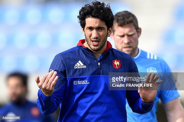 France's centre Maxime Mermoz gestures during a training session on March 13, 2015 in Marcoussis, south of Paris, ahead of their Six Nations...