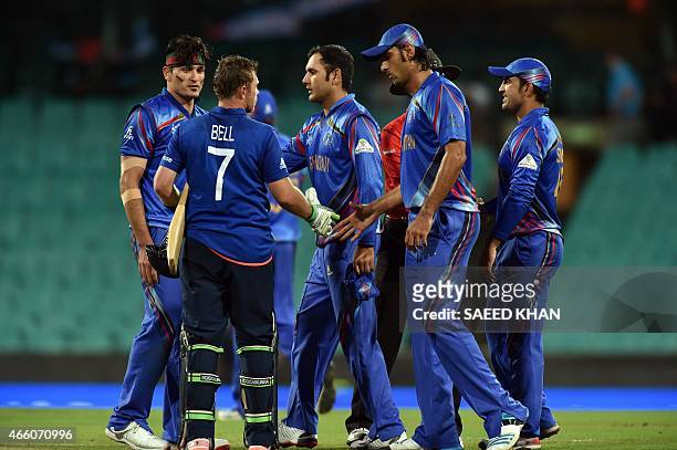 Afghanistan team players greet England's batsman Ian Bell over his team's victory during the 2015 Cricket World Cup Pool A match between England and...