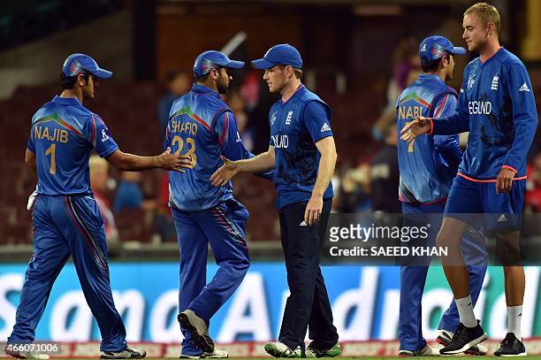 England's captain Eoin Morgan and Stuart Broad shake hands with Afghanistan players following their victory in the 2015 Cricket World Cup Pool A...