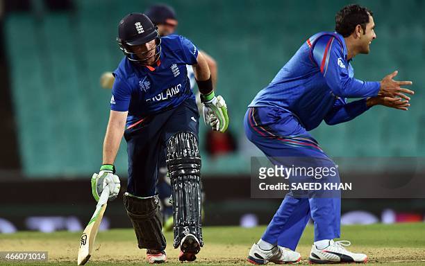 England's batsman Ian Bell completes the winning run for his team as Afghanistan's captain Mohammad Nabi reacts during the 2015 Cricket World Cup...
