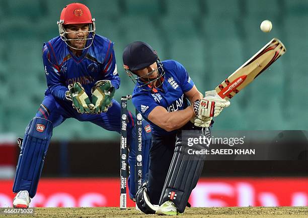 England's batsman James Taylor plays a shot as Afghanistan's wicketkeeper Afsar Zazai looks on during the 2015 Cricket World Cup Pool A match between...