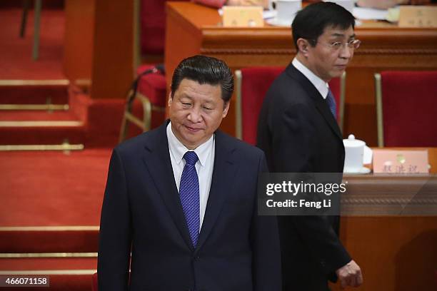 China's President Xi Jinping and member of the Political Bureau of the CPC Central Committee Wang Huning arrives at the closing session of the...