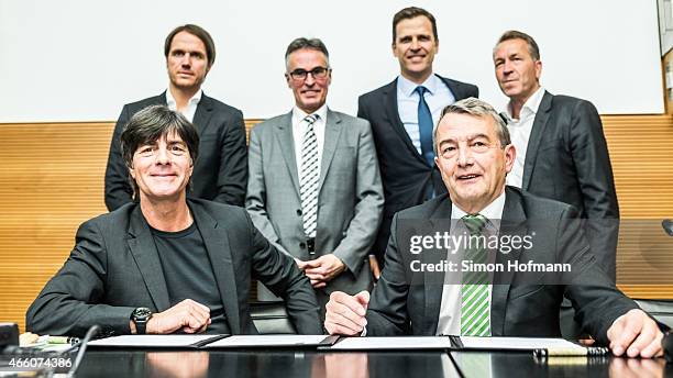 Joachim Loew, head coach of the German national football team , and DFB President Wolfgang Niersbach pose with Thomas Schneider, Helmut Sandrock,...