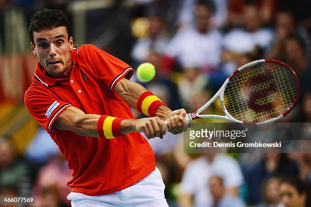 Roberto Bautista Agut of Spain plays a backhand in his match against Philipp Kohlschreiber of Germany on day 1 of the Davis Cup First Round match...
