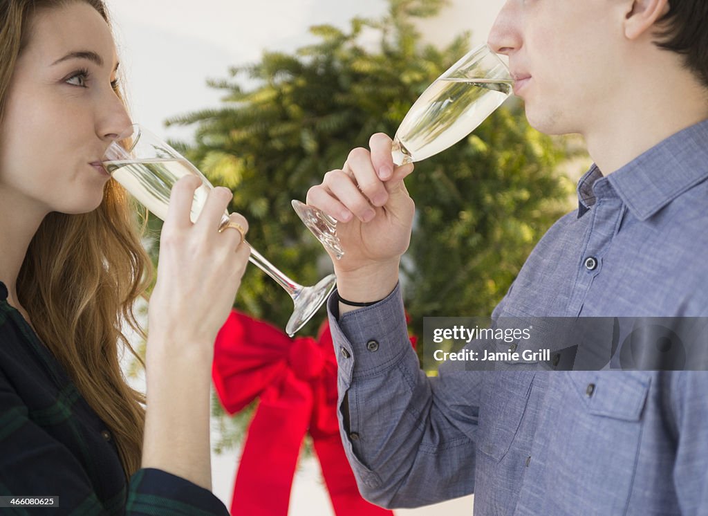 Couple drinking champagne at Christmastime