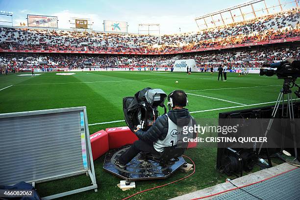 An image taken on March 1, 2015 shows a television cameraman working during the Spanish league football match Sevilla FC vs Club Atletico de Madrid...