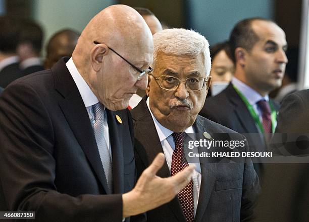 Palestinian president Mahmud Abbas and Lebanese Prime Minister Tammam Salam arrive for the Egypt Economic Development conference on March 13 in the...